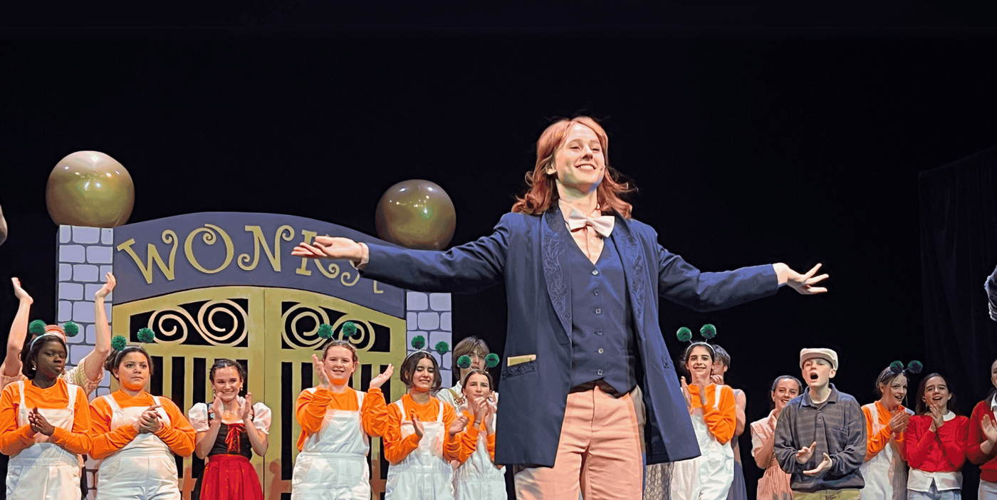 The cast of the Willy Wonka play receive applause on stage